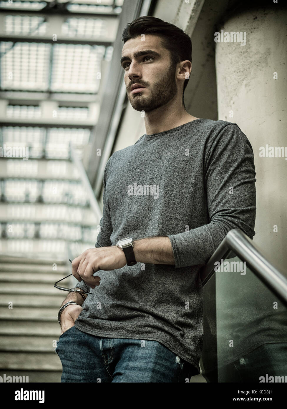 Handsome young man walking on stairway Stock Photo - Alamy