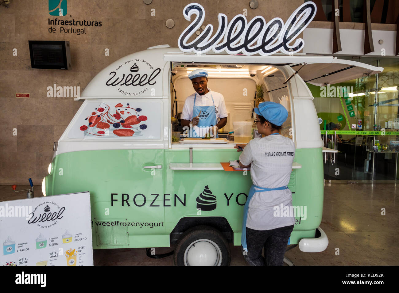 Lisbon Portugal,Rossio Square,Pedro IV Square,Rossio Railway Station,Weeel,frozen yogurt,mobile food cart,retro trailer,Black man men male,woman femal Stock Photo
