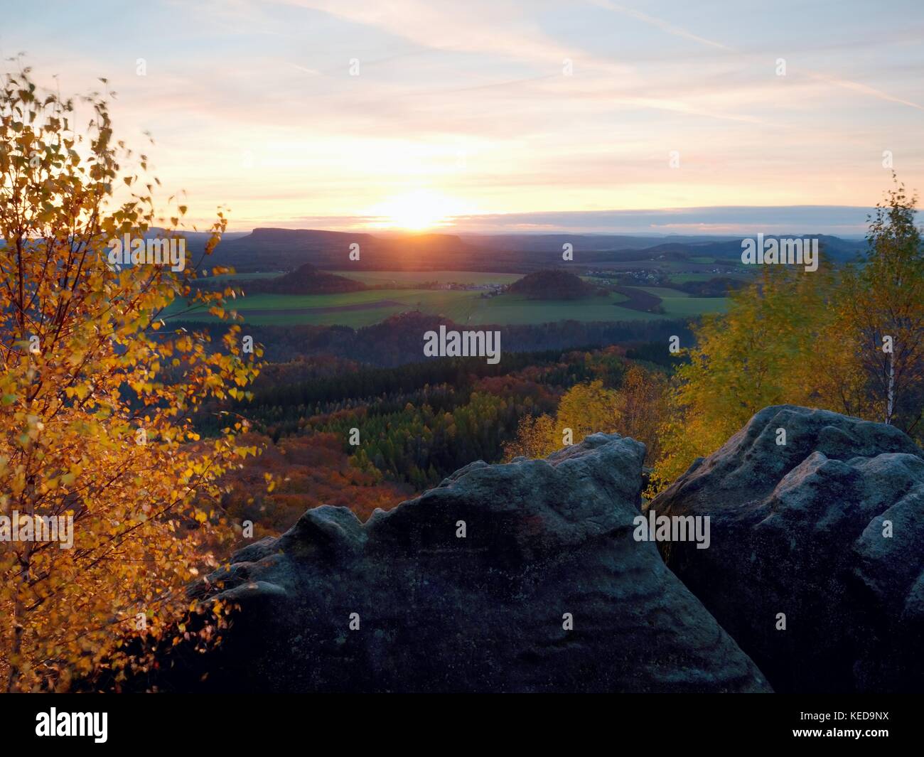 Fantastic dreamy sunset on top of rocky mountain with view into evening ...