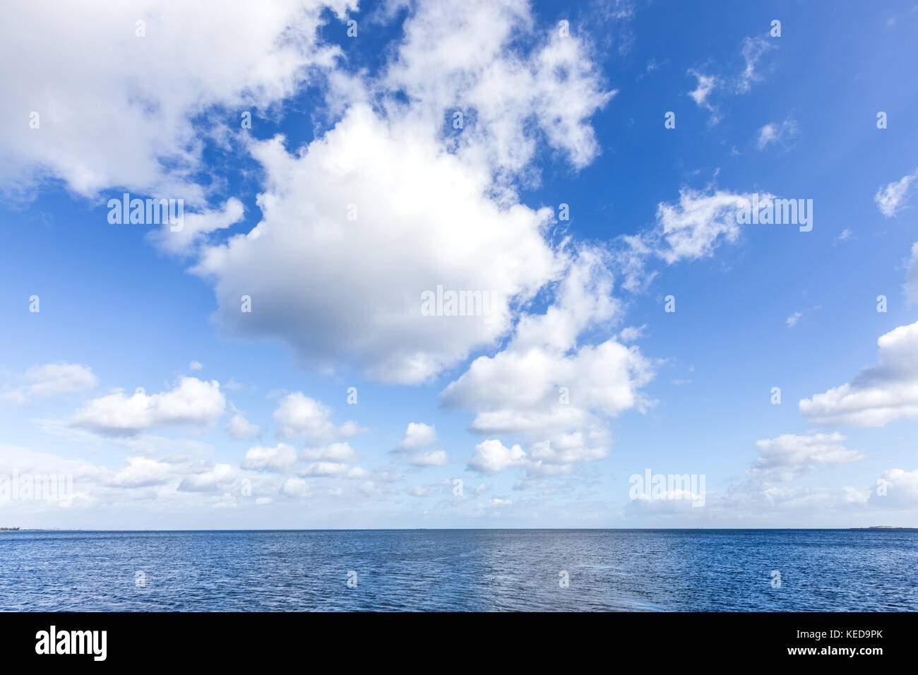Beautiful sea under cloudy blue sky, background Stock Photo - Alamy