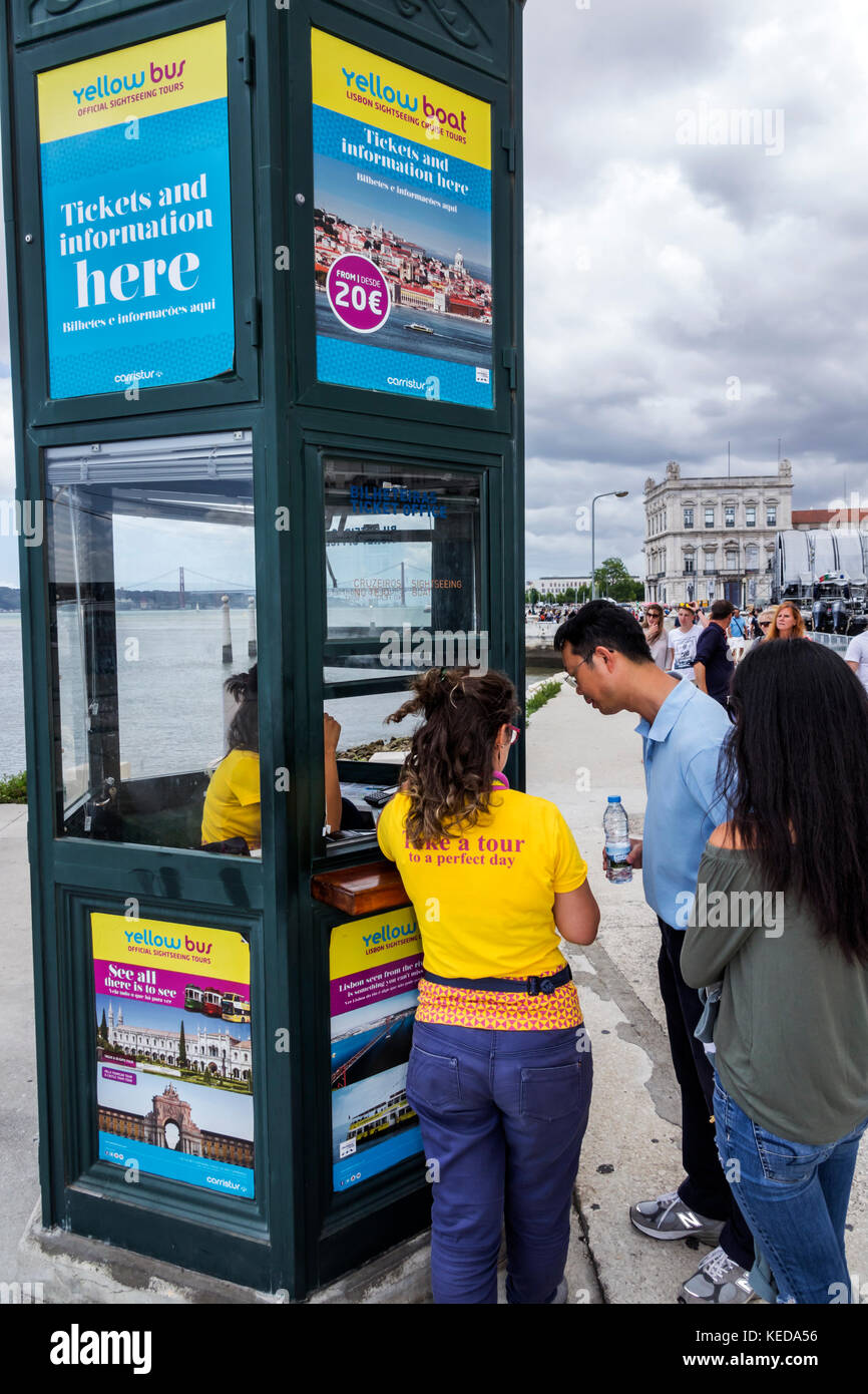 Lisbon Portugal,Baixa Pombalina,Terreiro do Paco,yellow boat,sightseeing tours,ticket kiosk,Asian man men male,woman female women,couple,Hispanic,immi Stock Photo