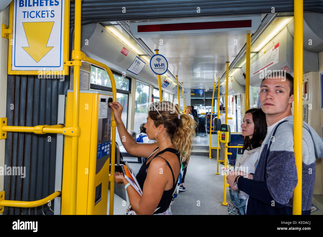 Lisbon Portugal,Carris,Tram 15,Belem Highway Route,onboard ticket vending machine,man men male,woman female women,transaction paying pays buying buys, Stock Photo