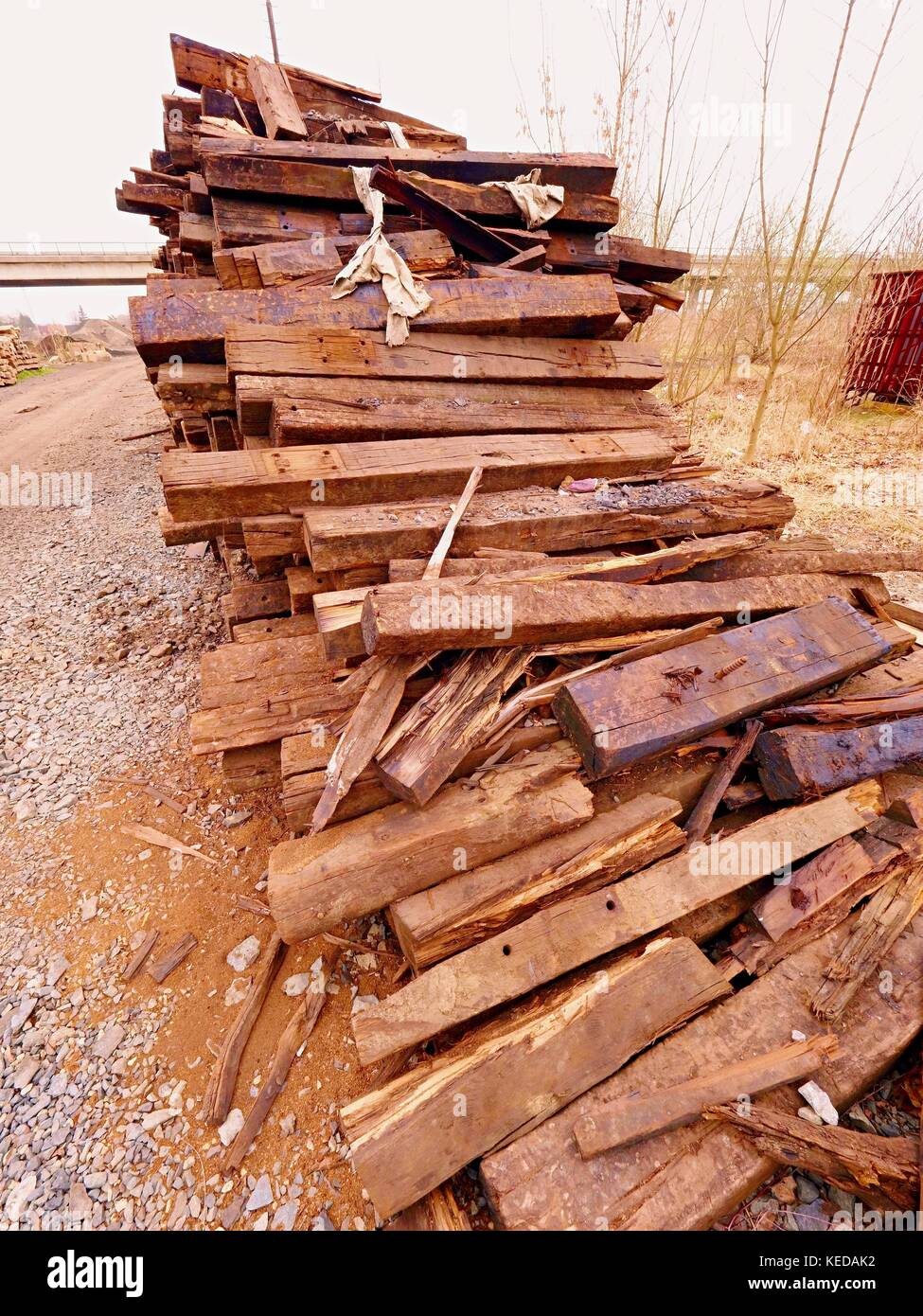 Terrible smell pile of extracted old wooden ties. Old oiled used oak