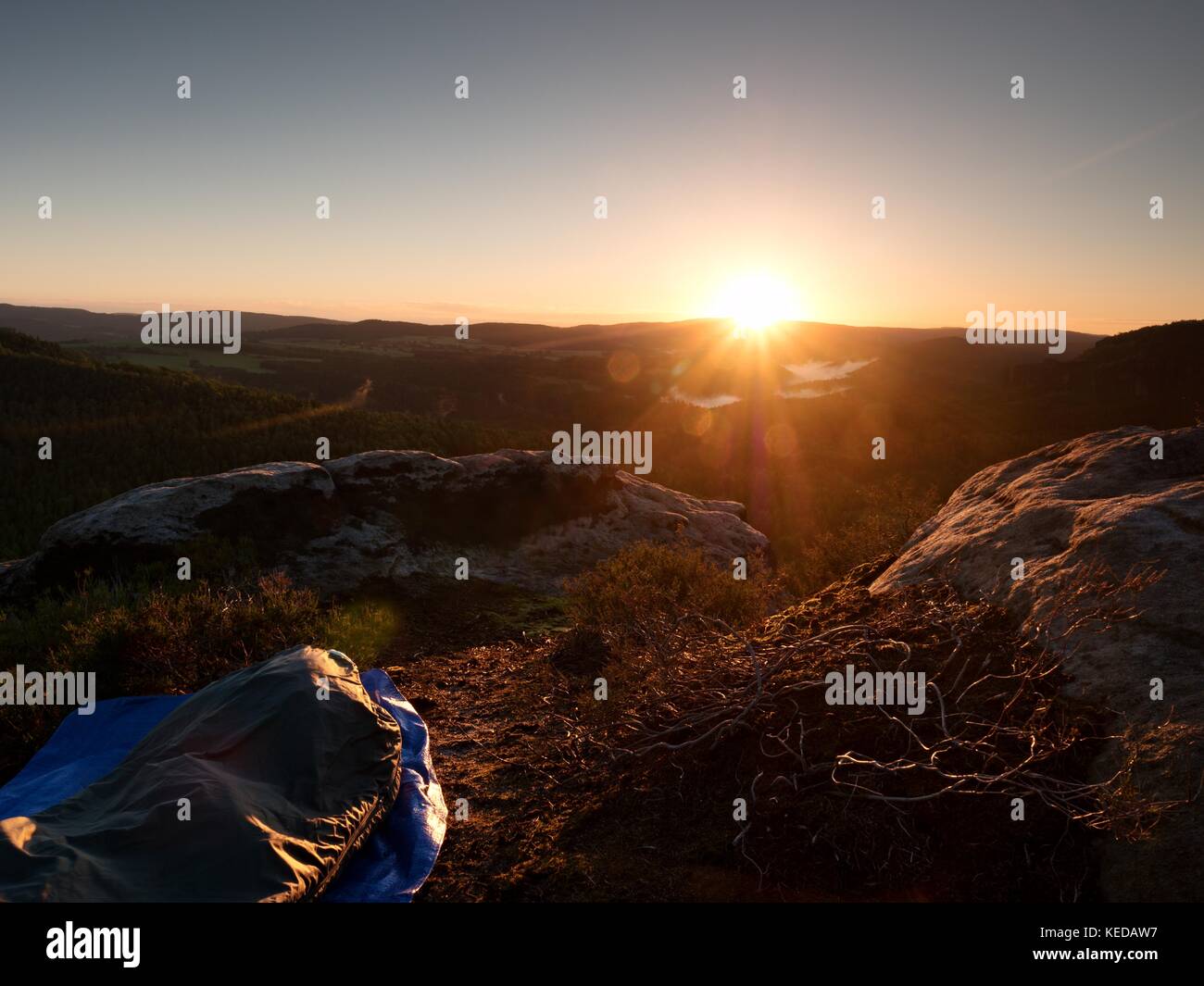 Beautiful awakening in rocks. Sleeping in nature in sleeping bag. View
