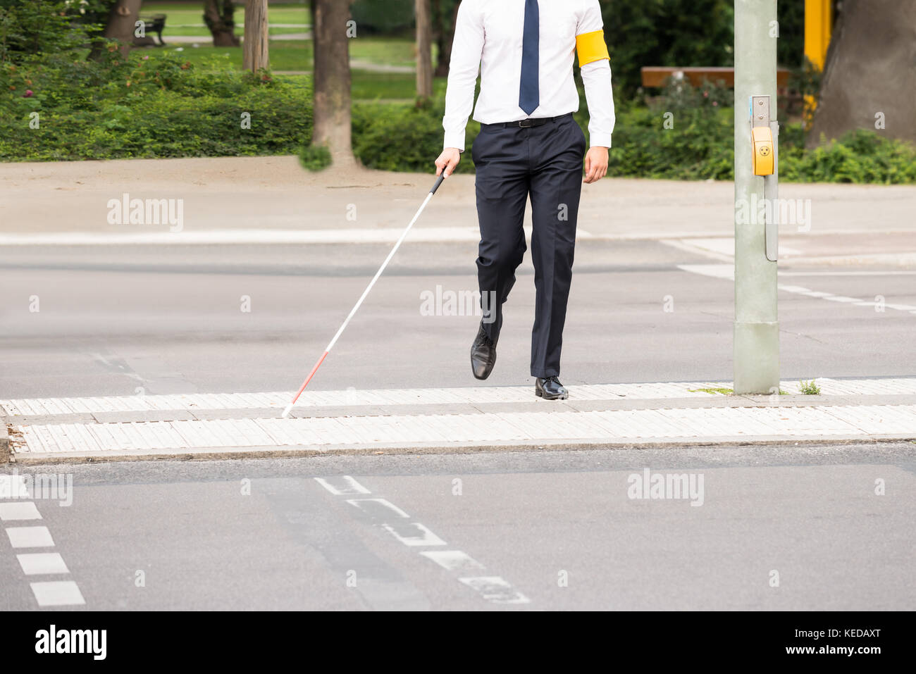 Blind Person With White Stick Walking On Street Stock Photo