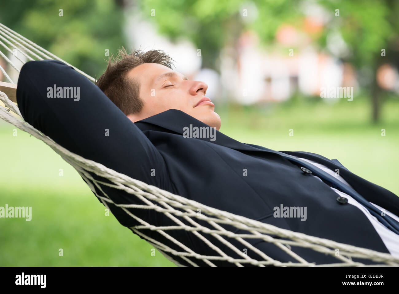 Close-up Of Young Man Lying In Hammock Stock Photo