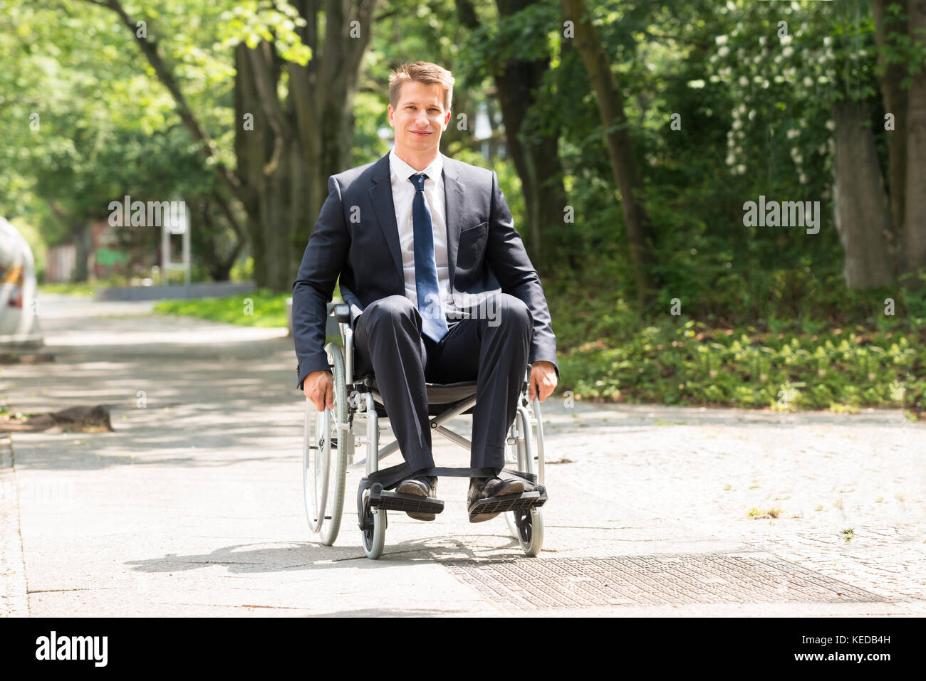 Portrait Of Young Happy Disabled Man On Wheelchair Stock Photo