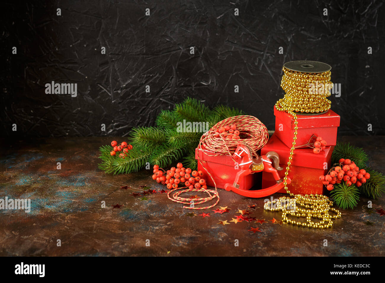 Christmas decorations with lights, toys and red gifts boxes on dark background, New Year and Christmas decoration Stock Photo