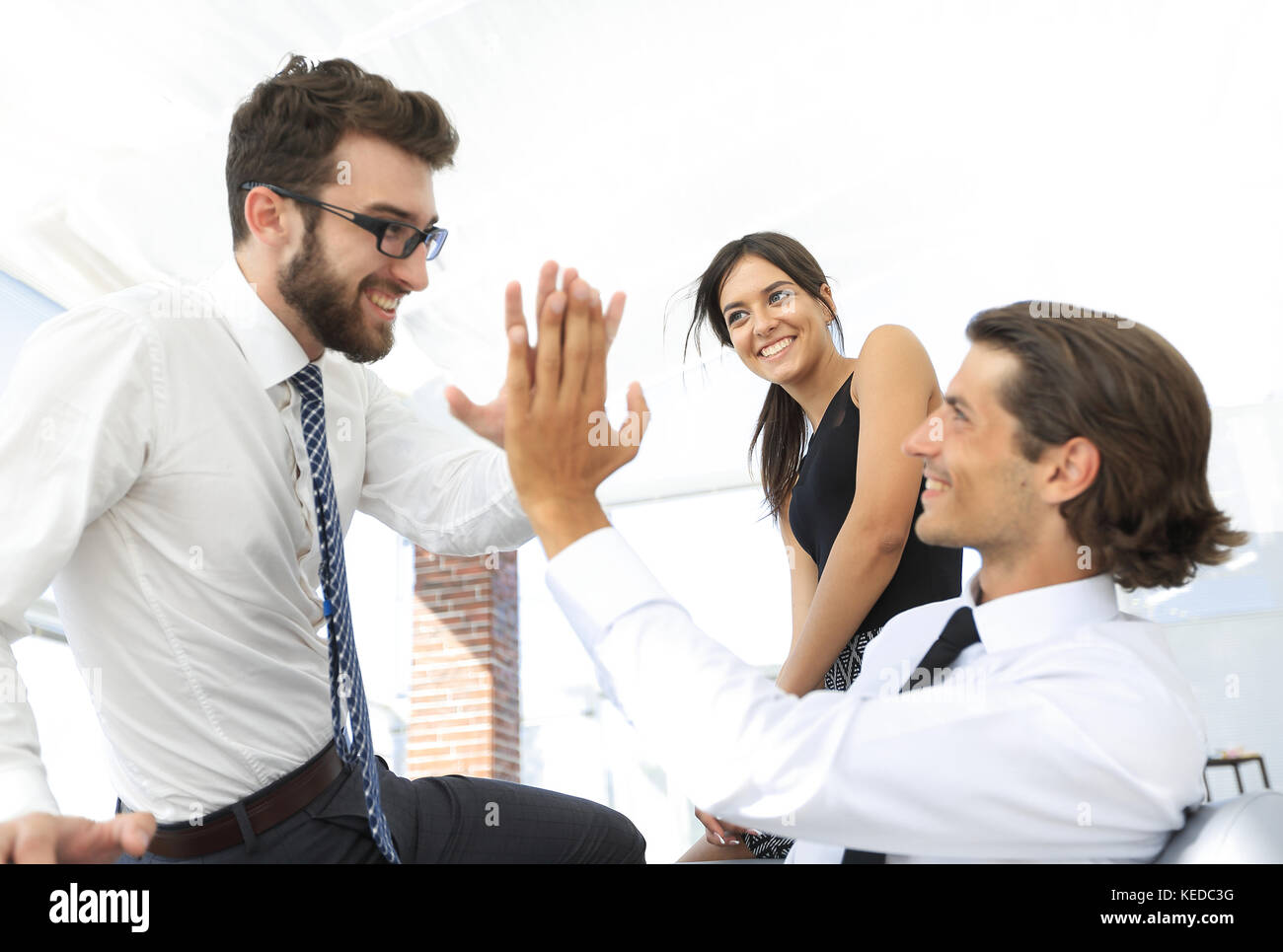 business colleagues giving each other high five Stock Photo - Alamy