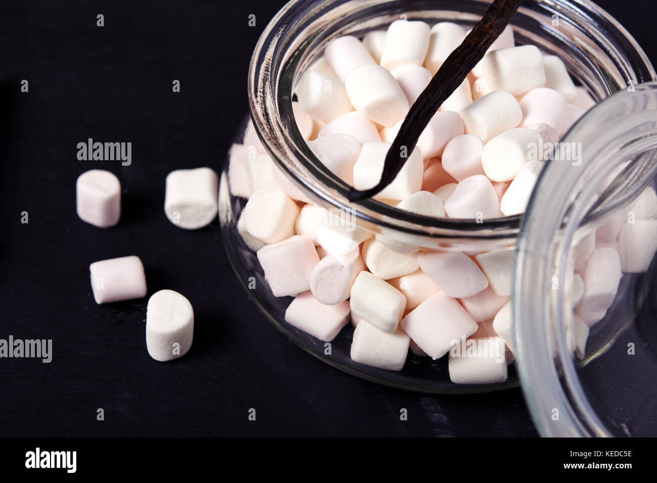 marshmallow in glass jar over dark background Stock Photo Alamy