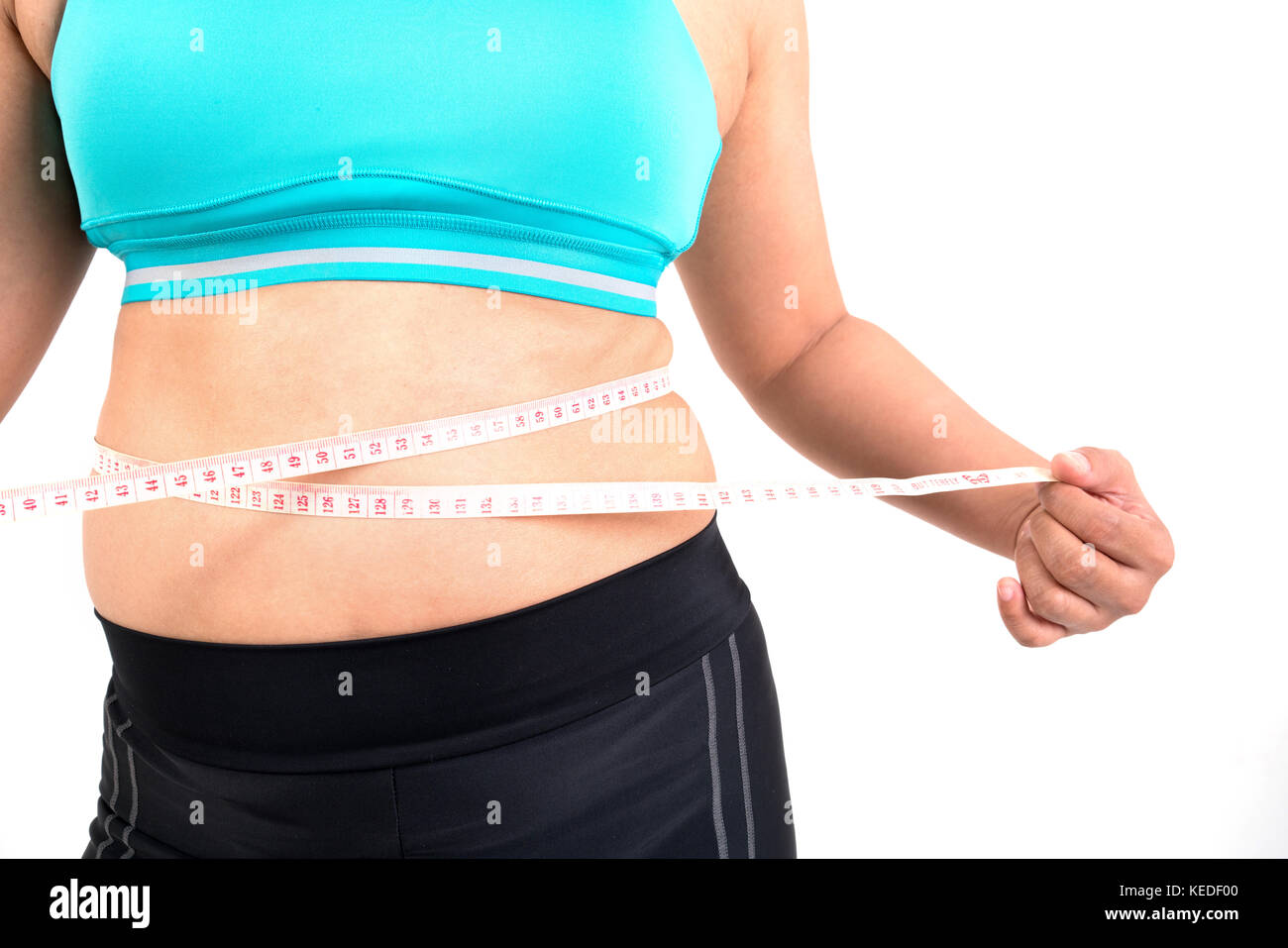 chubby  woman measuring her waistline fat tummy Stock Photo