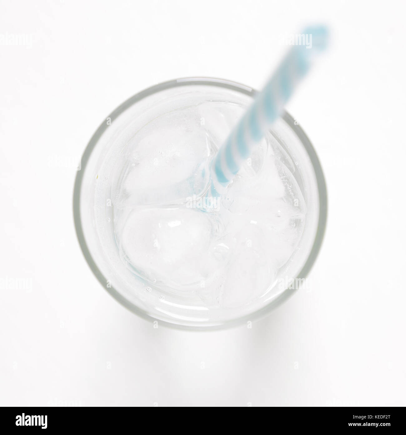 glass with ice cubes on white painted table Stock Photo - Alamy