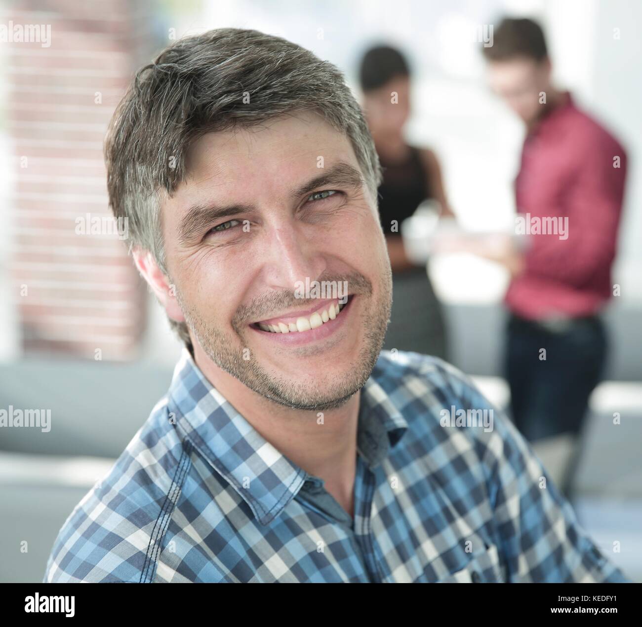 Casual businessman with arms crossed standing in the office Stock Photo ...