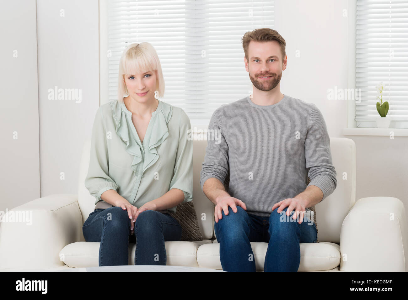 Relaxed couple sitting couch hi-res stock photography and images - Alamy