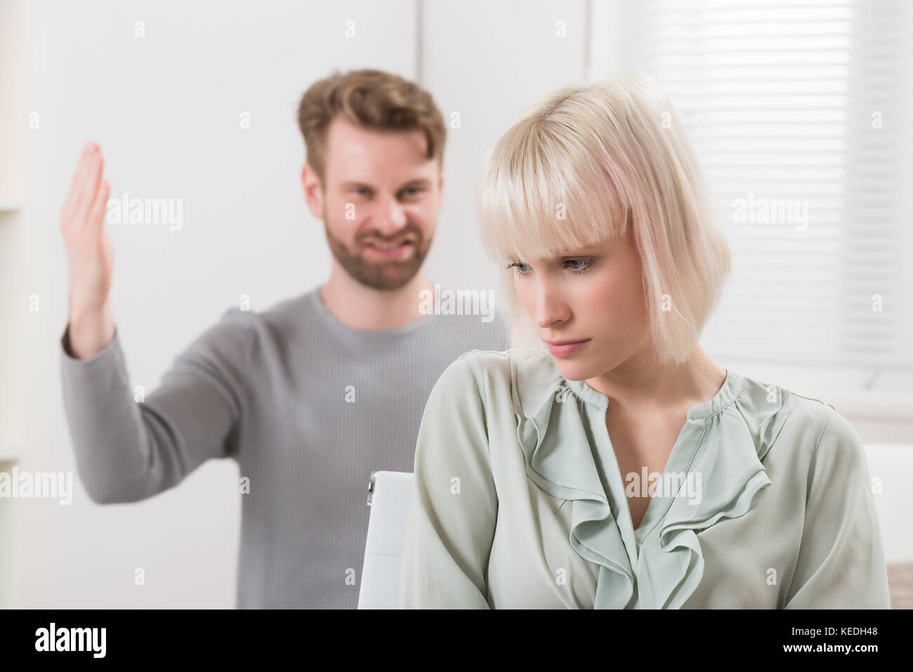 Frustrated Young Man Having Argument With Unhappy Woman At Home Stock Photo