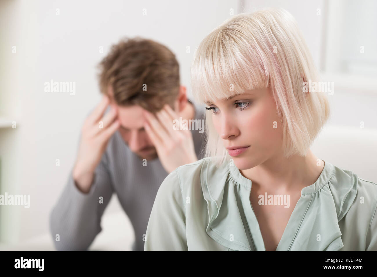 Sad Young Couple Having Argument At Home Stock Photo
