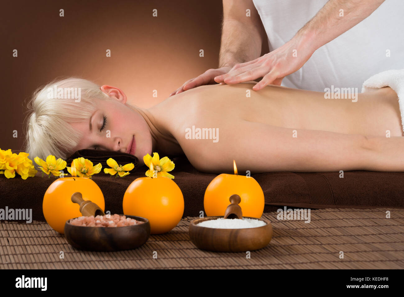 Smiling Young Woman Receiving Shoulder Massage From A Massager In A Beauty Spa Stock Photo