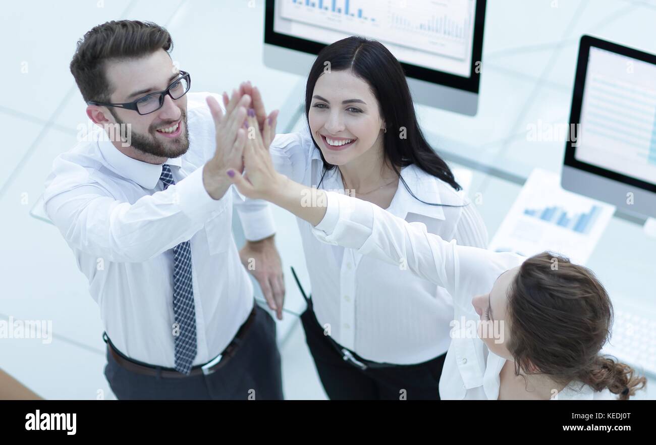 successful business team giving each other a high five Stock Photo - Alamy
