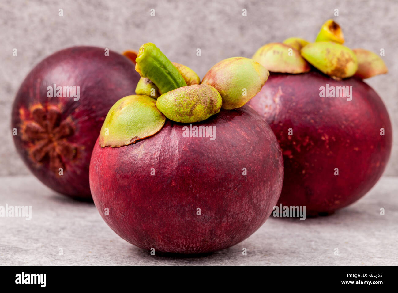 Delicious mangosteen fruit arranged on stone background.Mangosteen the queen of thai fruits