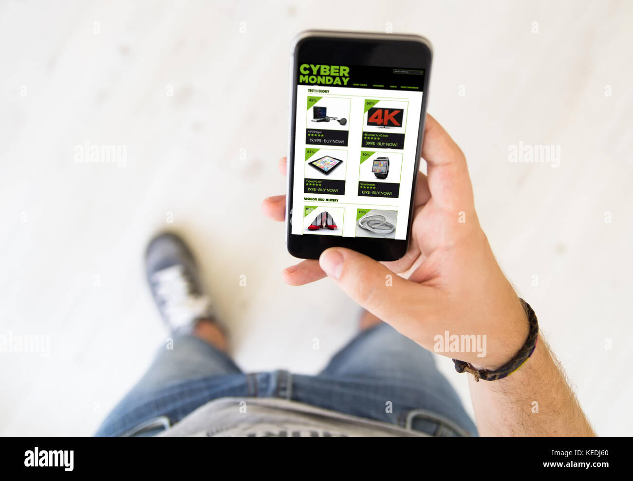 close up of male hand shopping on cyber monday with smart phone Stock Photo