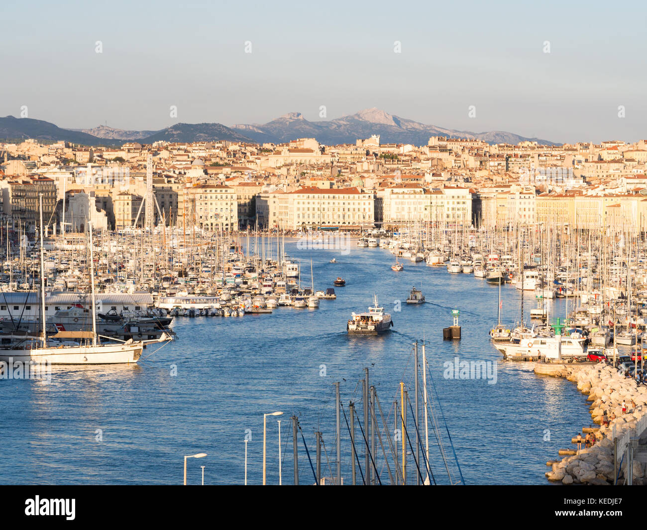 MARSEILLE, FRANCE - AUGUST 07, 2017: The old Vieux Port of Marseille beneath Cathedral of Notre Dame, France, at sunset. Stock Photo