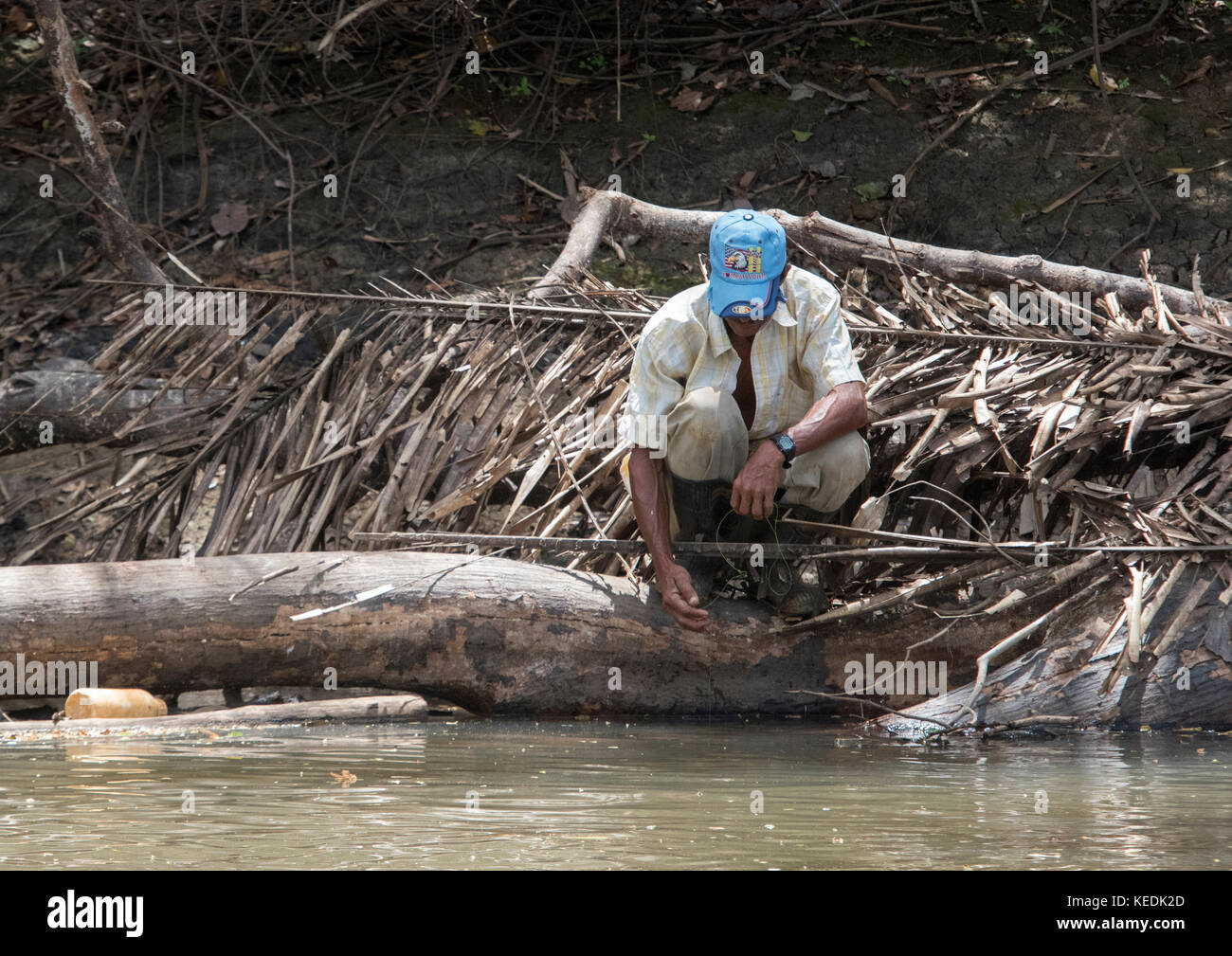Despite crocodiles, a man is fishing on the Sarapiqui River, Costa Rica Stock Photo