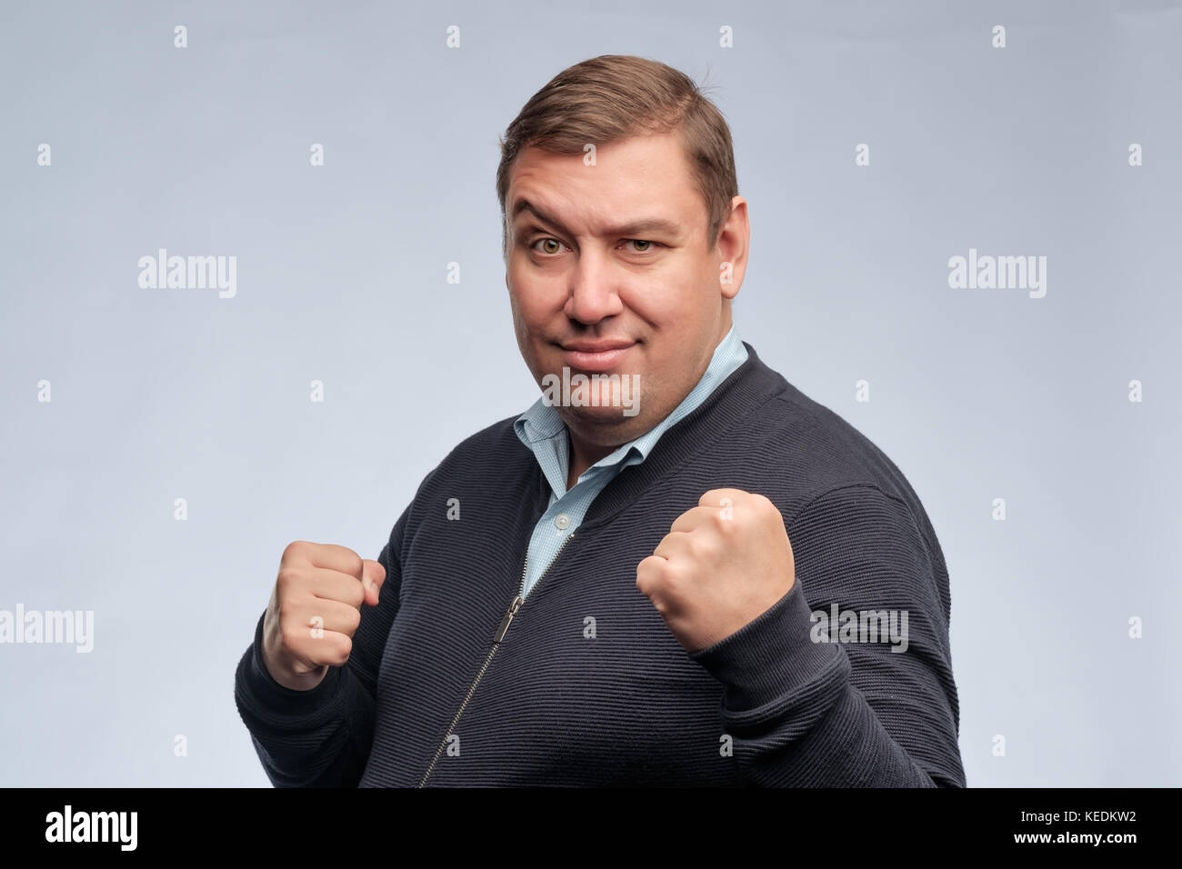 Half body portrait of confident middle aged man with folded arms looking at camera Stock Photo
