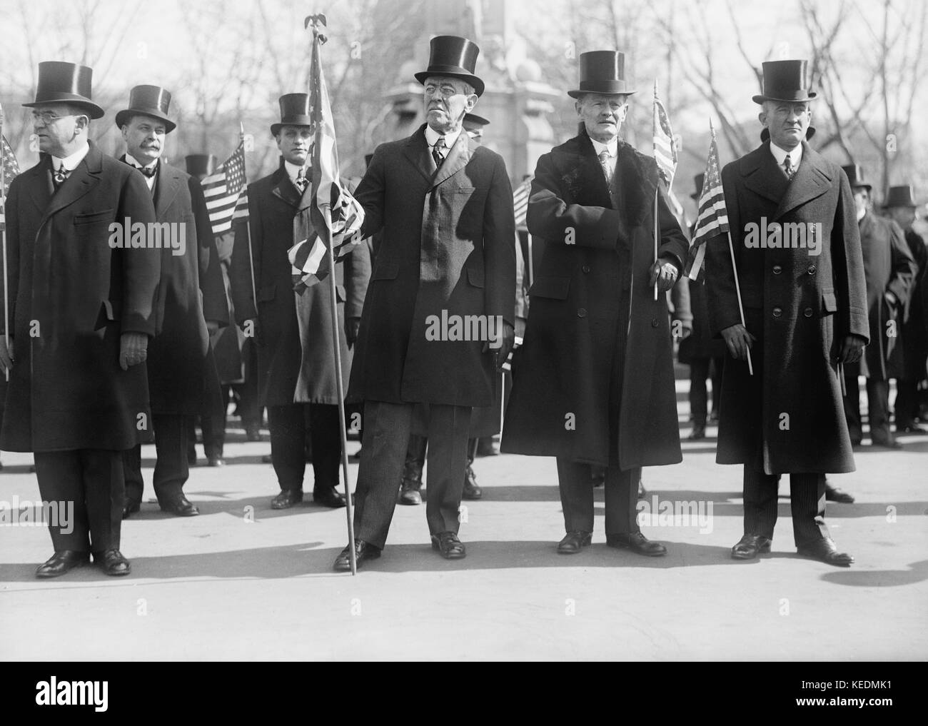 President Woodrow Wilson (center),Vice President Thomas Marshall to Wilson's left,Holding American Flags during Parade Honoring Wilson's Return from Paris Peace Conference,Washington DC,USA,Harris & Ewing,March 1919 Stock Photo