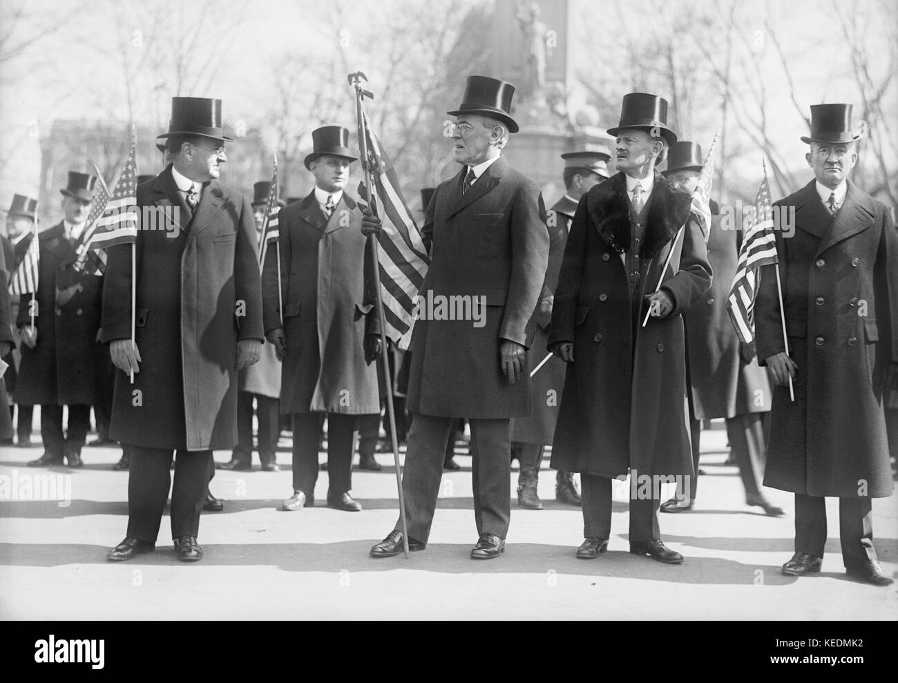 President Woodrow Wilson (center),Vice President Thomas Marshall to Wilson's left,Holding American Flags during Parade Honoring Wilson's Return from Paris Peace Conference,Washington DC,USA,Harris & Ewing,March 1919 Stock Photo