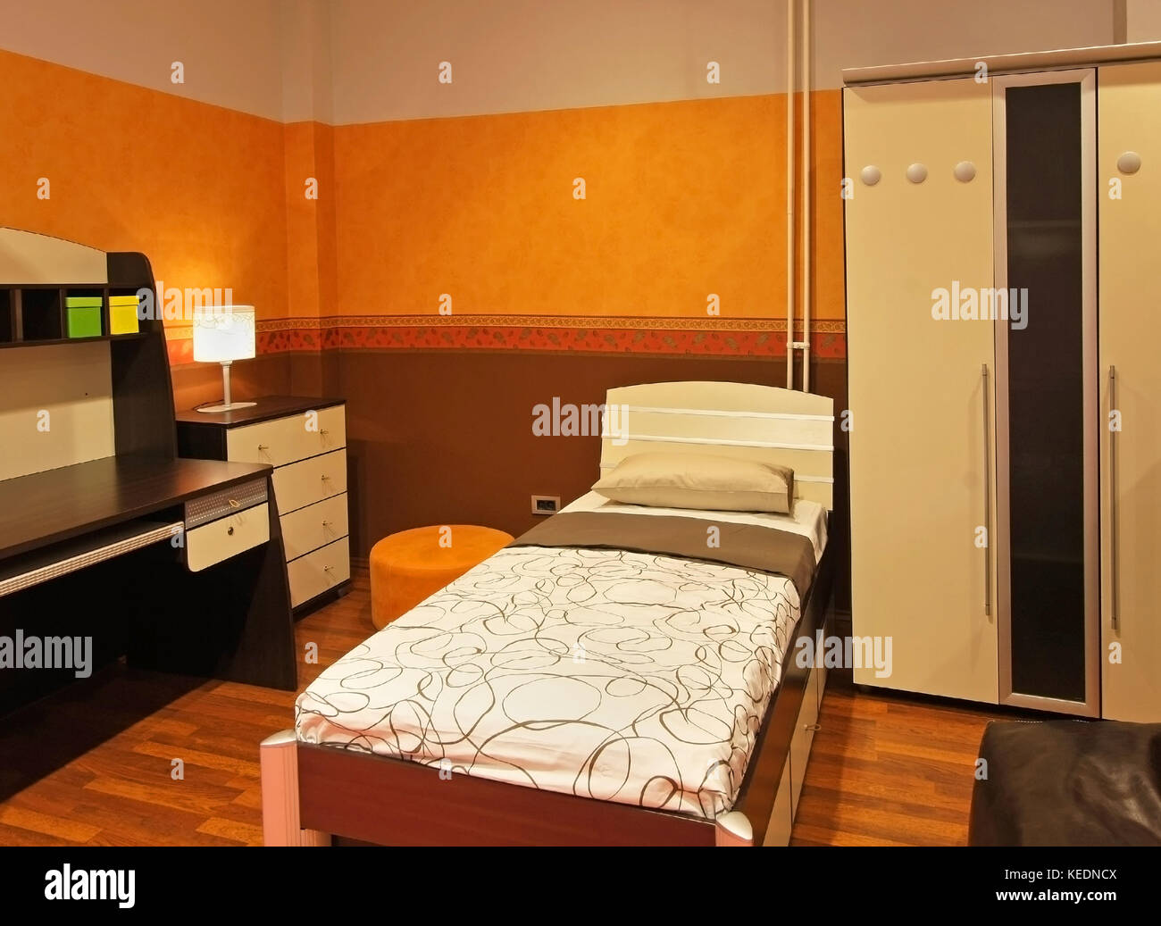 Modern child bedroom interior with orange wall and brown furniture ...