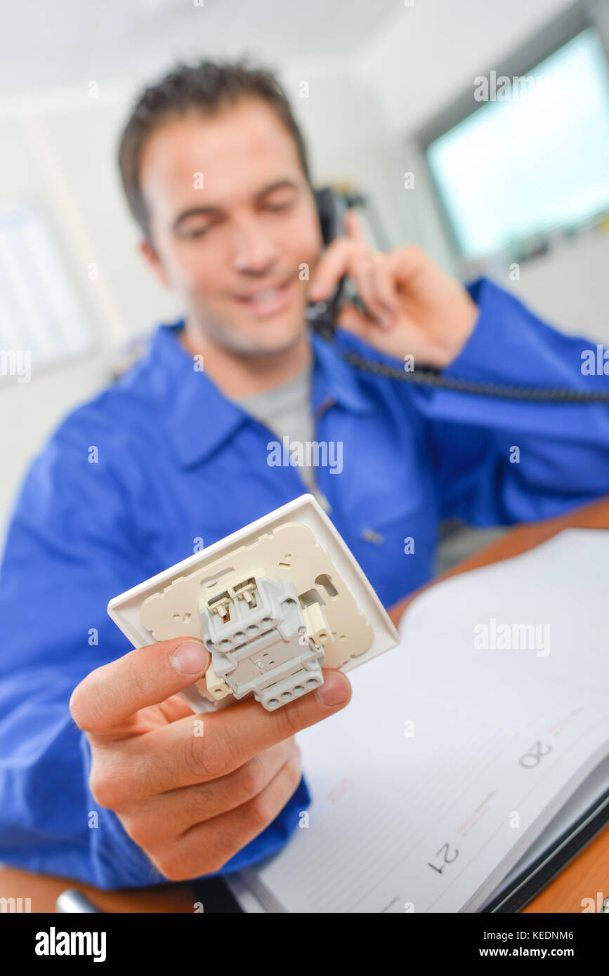 man holding a light switch mechanism Stock Photo - Alamy