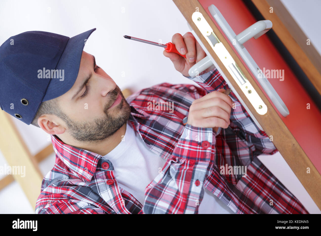 man fixing a lock in old door Stock Photo Alamy