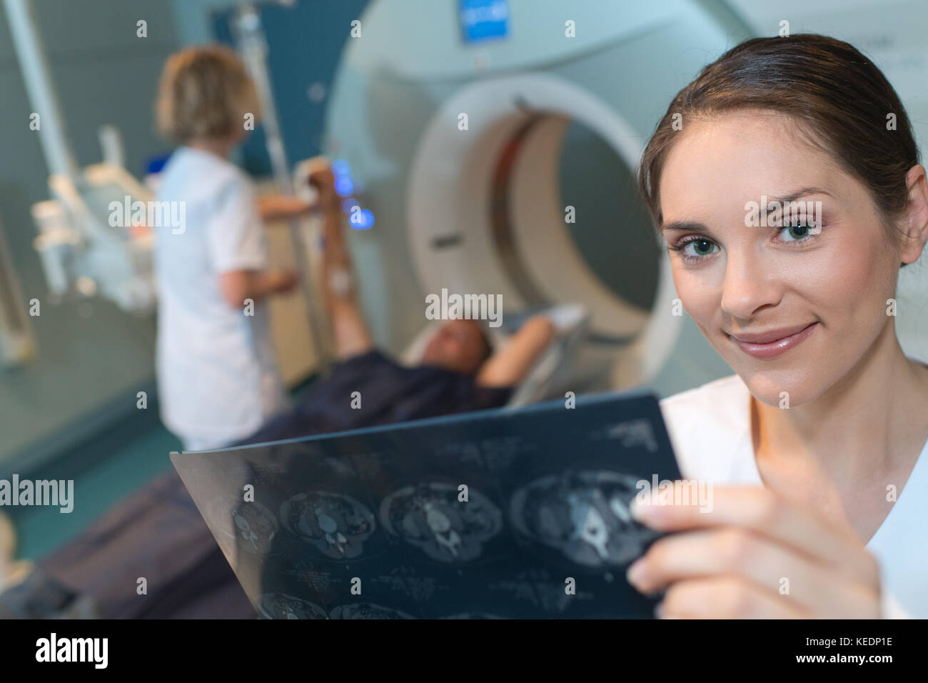 Medical worker holding up scanner results Stock Photo