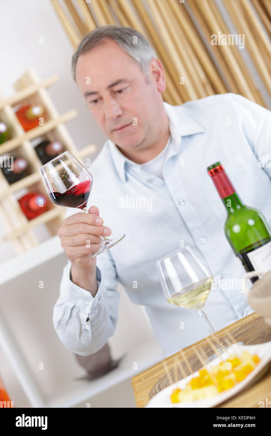 mature man drinking a glass of red wine at home Stock Photo - Alamy
