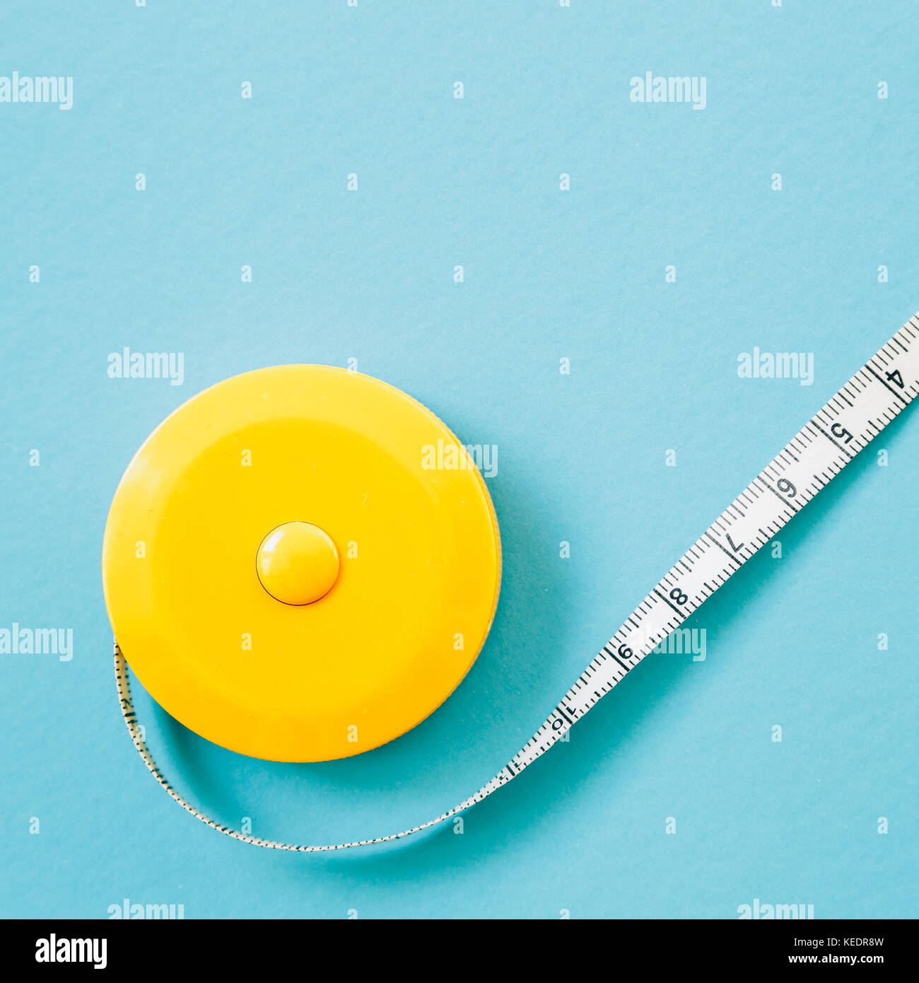 Tape measure on blue color background Stock Photo Alamy