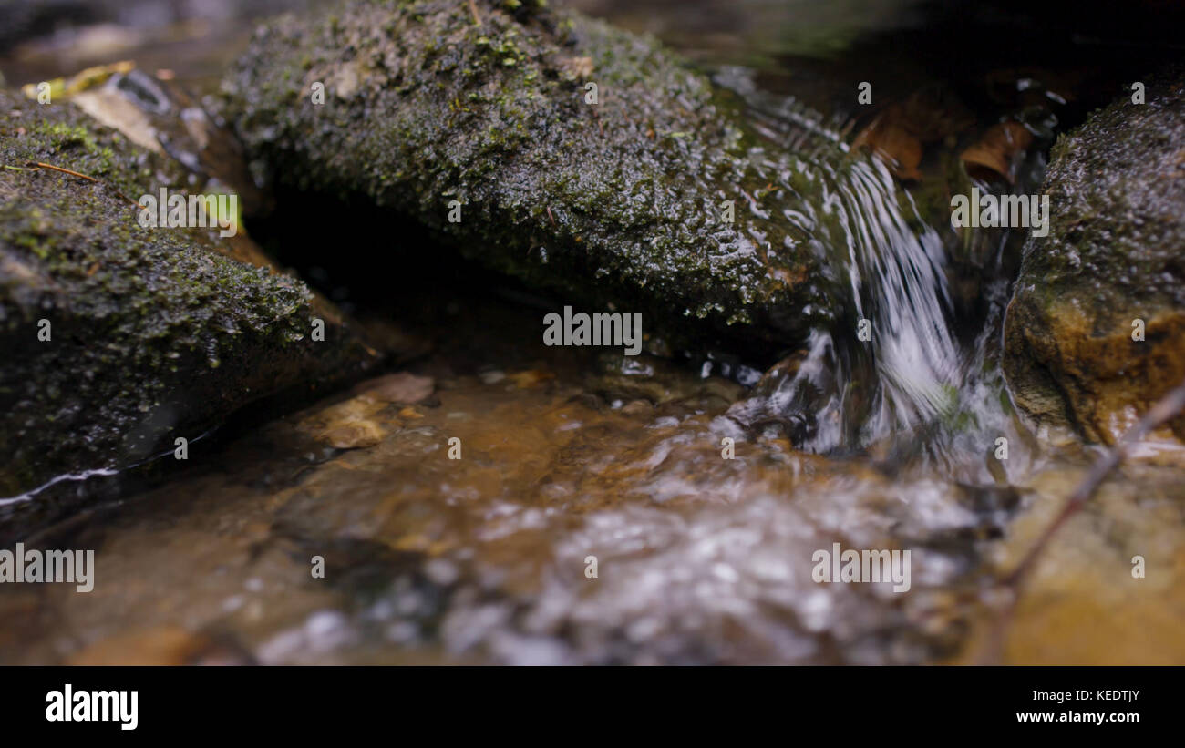 Water splash in river. Water in river close up with bubbles. Water
