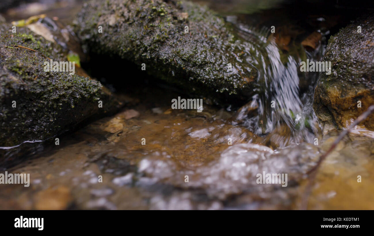 Water splash in river. Water in river close up with bubbles. Water