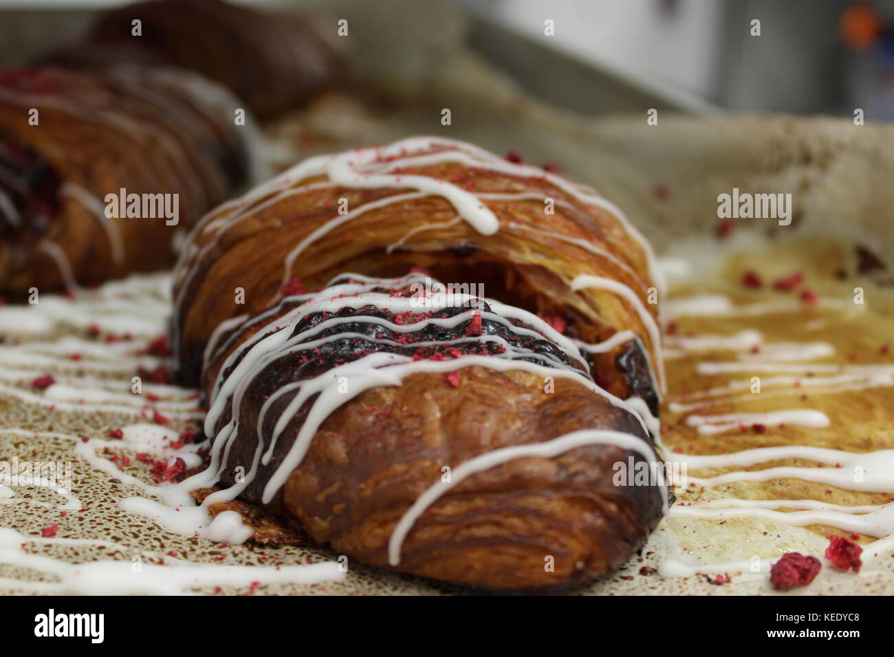 Fresh fruit filled croissant with icing Stock Photo