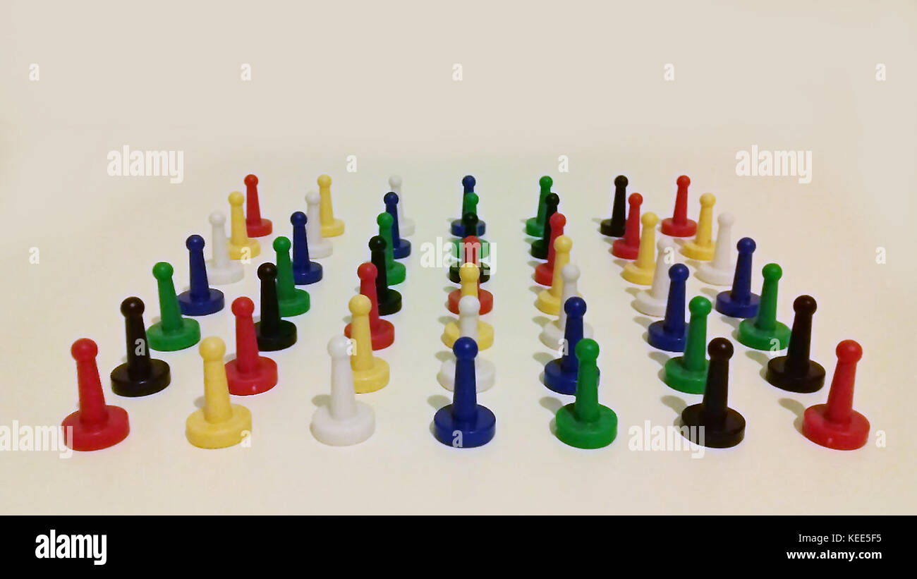 Multi-colored playing game pieces on white background Stock Photo
