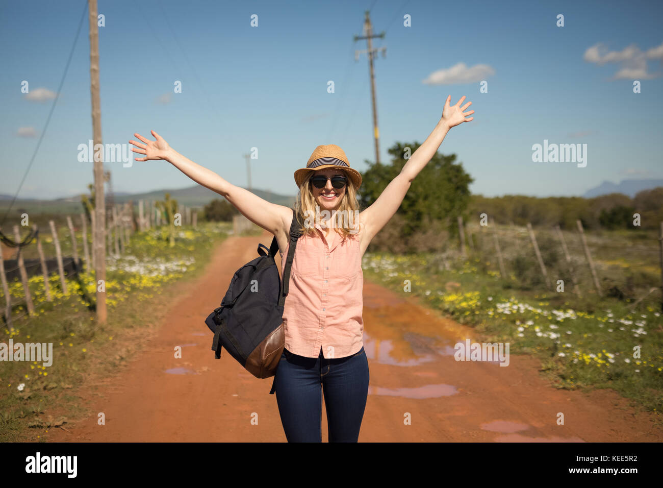 Blissful woman with her backpack on a sunny day Stock Photo