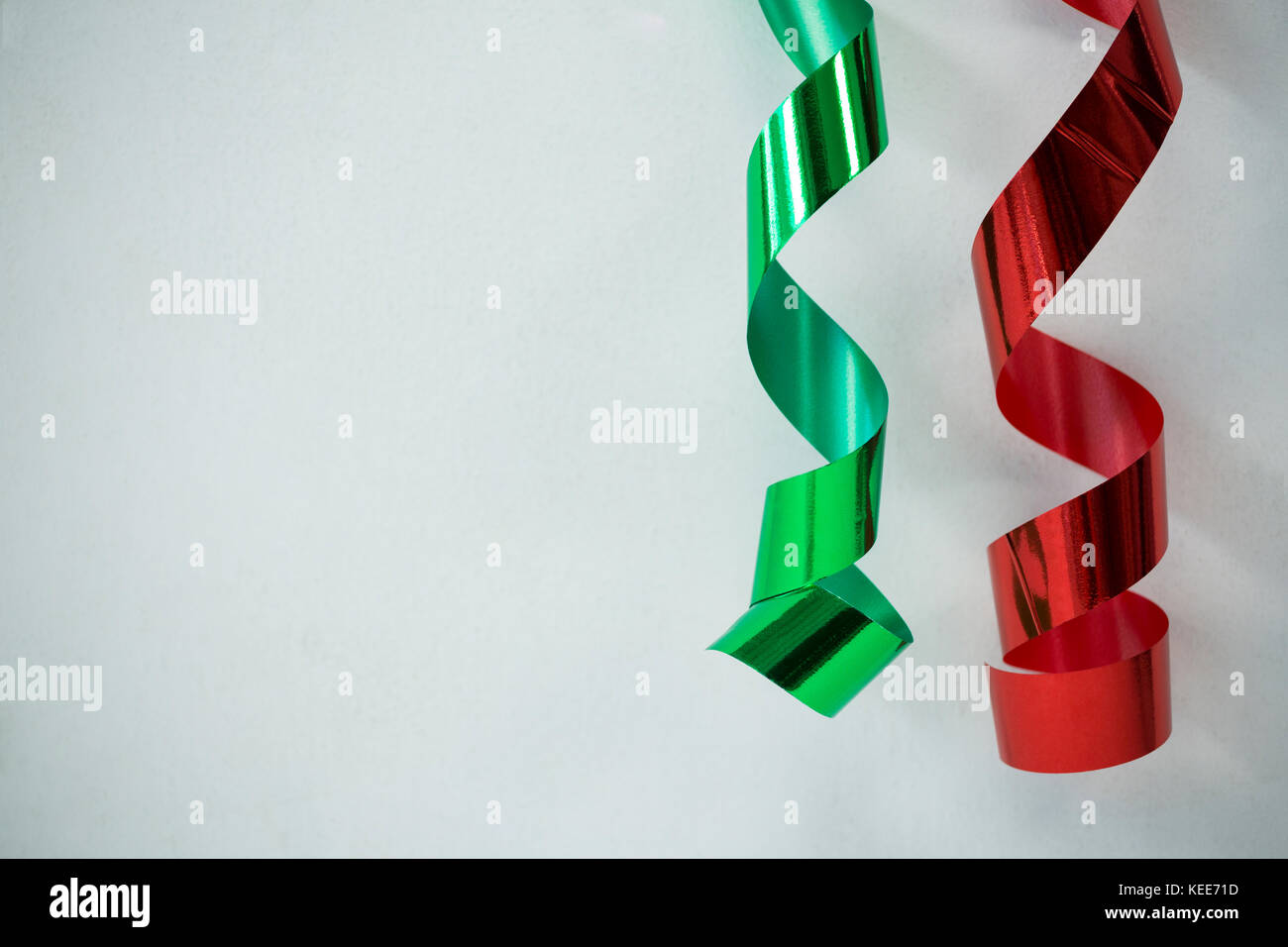 Close-up of red and green streamers on white background Stock Photo - Alamy