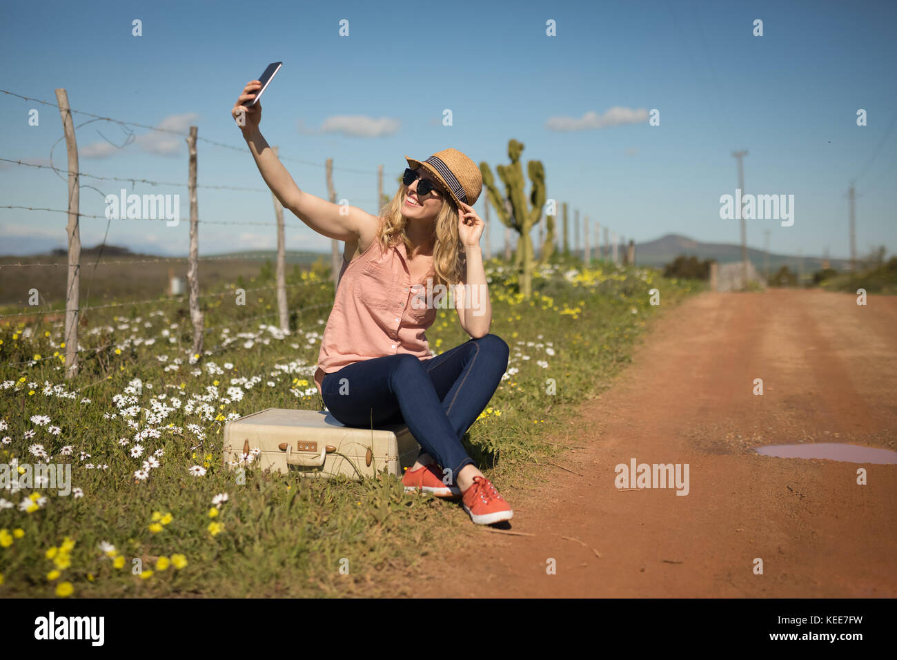 Woman taking selfie with mobile phone on a sunny day Stock Photo - Alamy
