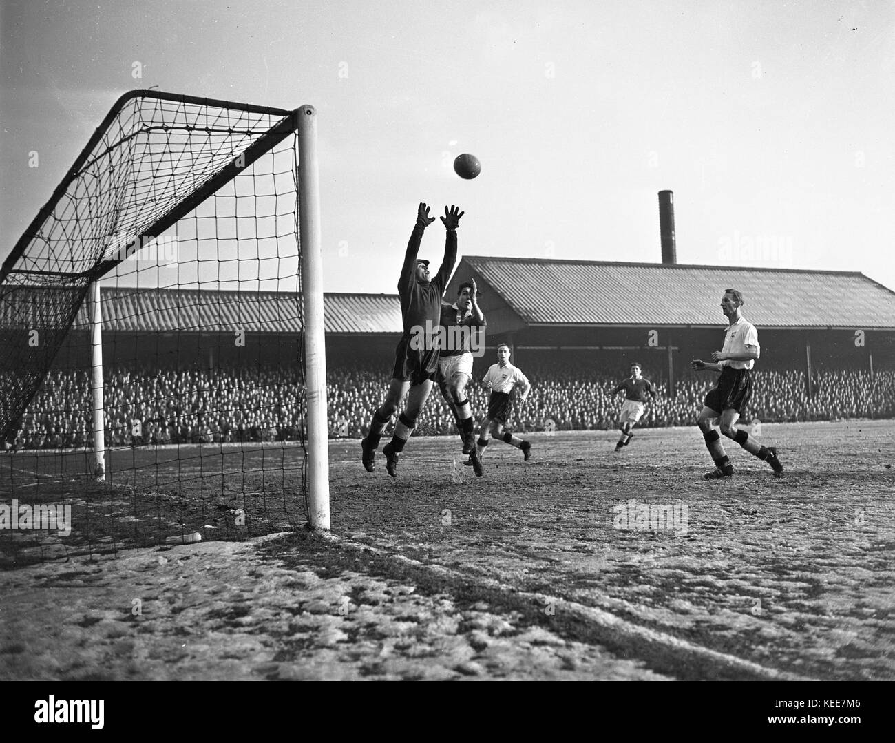 Goalkeeper Ray Middleton makes a save as Geoff Barrowcliff (centre) and Ken Oliver (right) of Derby County (right) look on in a match at Derby County's Baseball Ground.  Photograph by Tony Henshaw From the wholly-owned original negative. Stock Photo