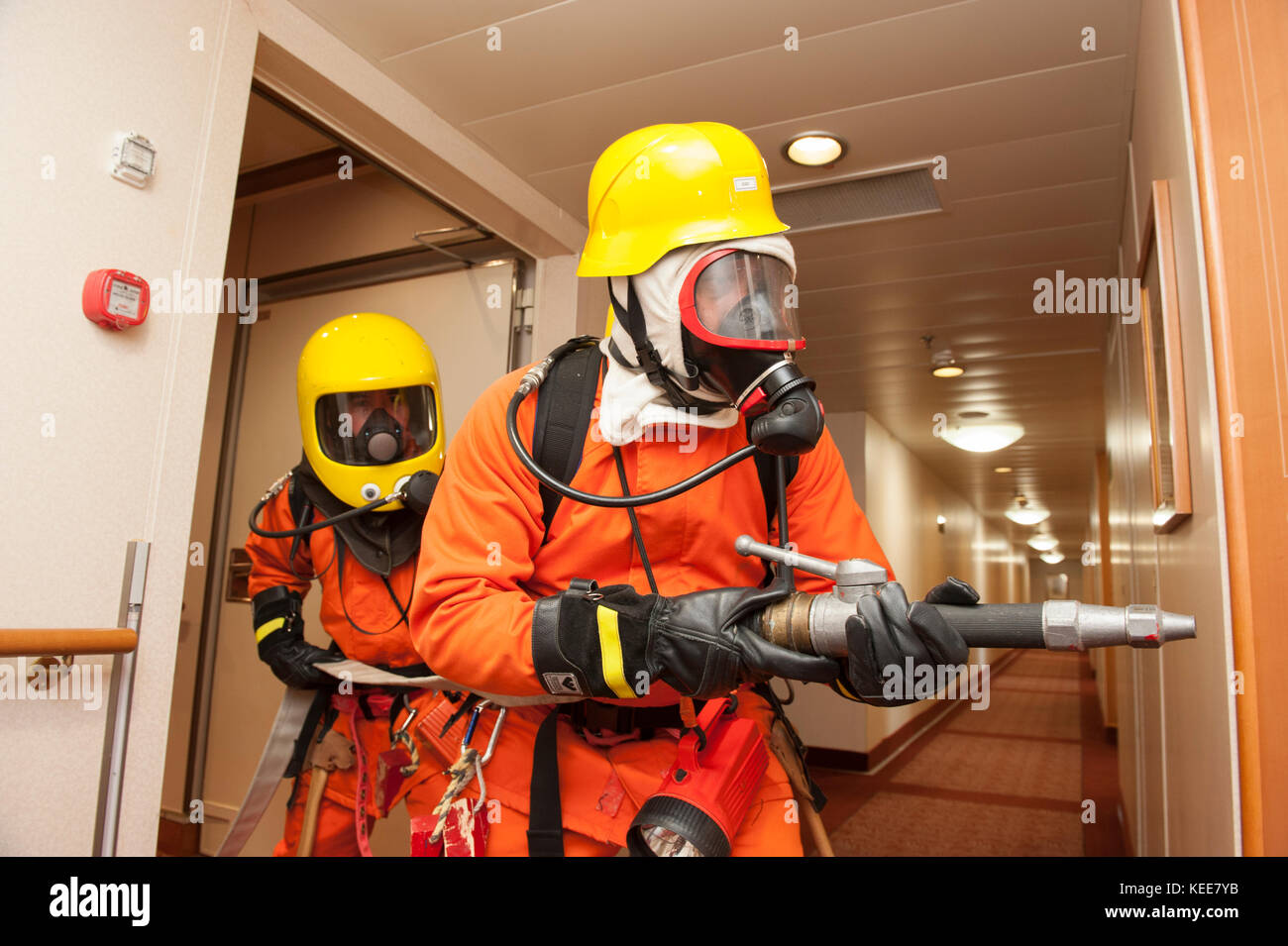 Crew firefighting practice on board a cruise ship Stock Photo