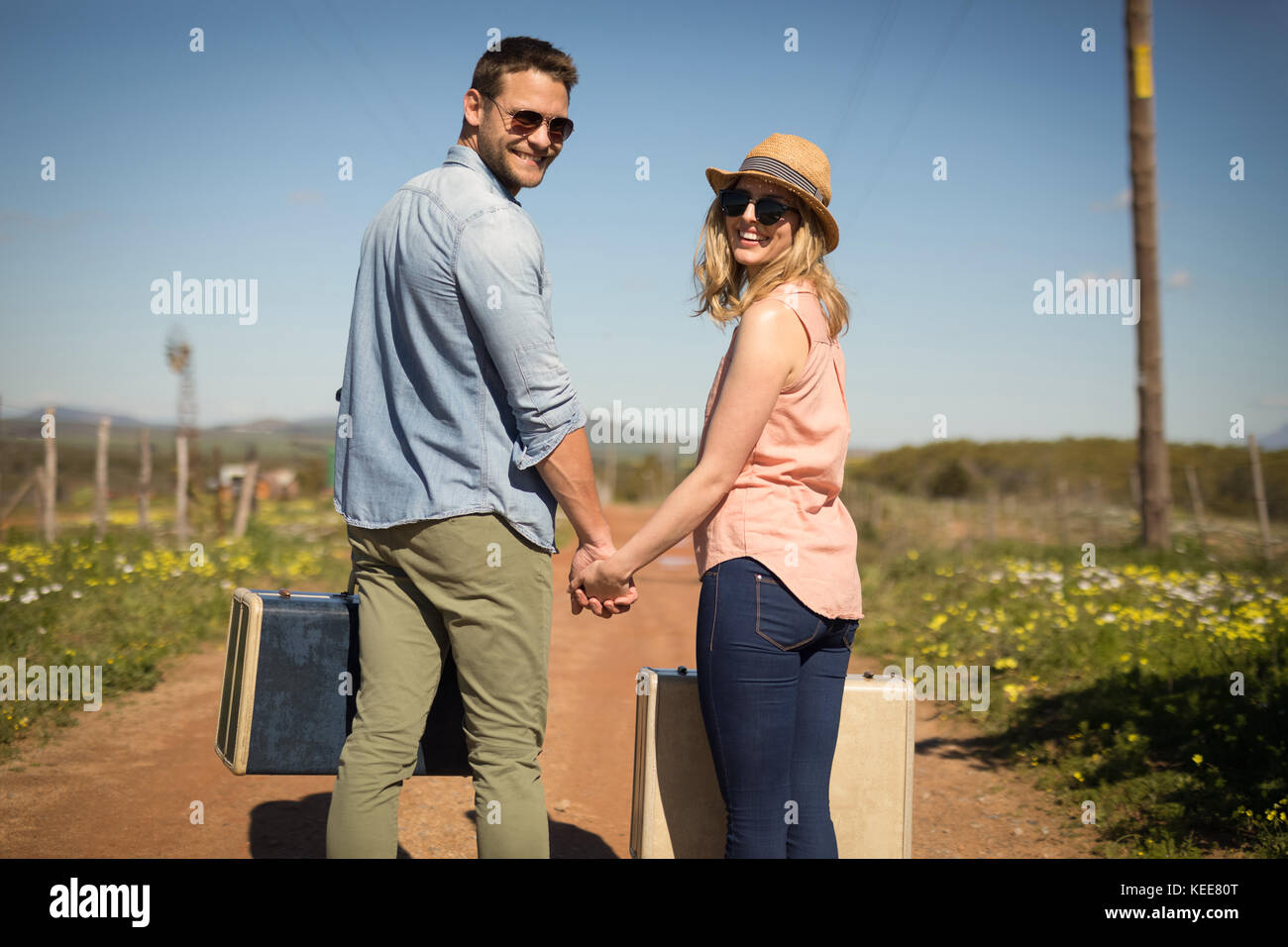 Happy man walking luggage hi-res stock photography and images - Alamy