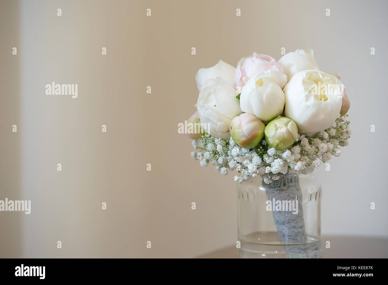 Off Centered White Peonies And Baby S Breath Wedding Bouquet Positioned In A Transparent Vase On A Small Table Stock Photo Alamy Off Centered White Peonies And Baby S Breath Wedding Bouquet Positioned In A Transparent Vase On A Small Table Stock Photo Alamy