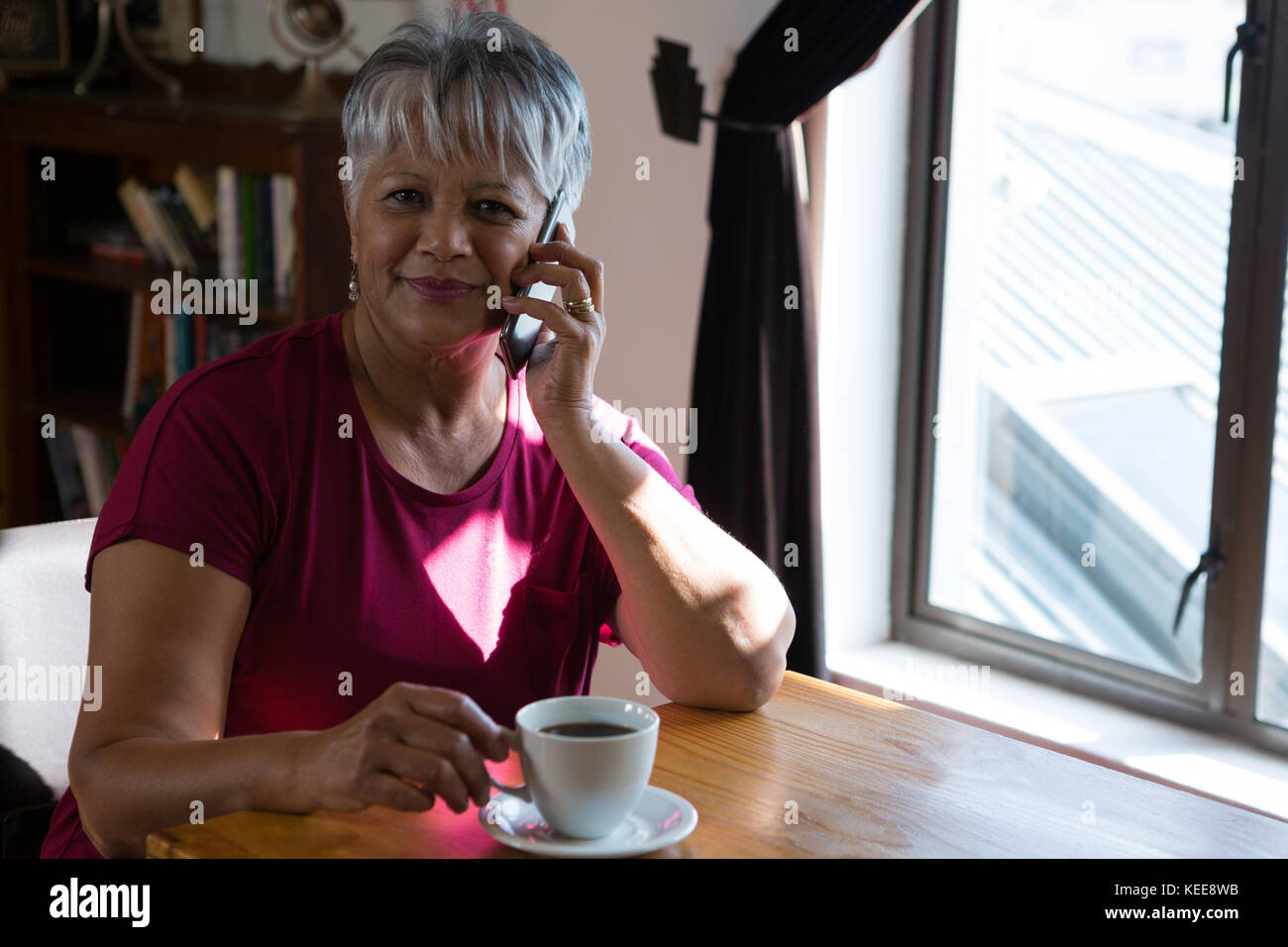 Senior woman talking on mobile phone in cafÃƒÂ© Stock Photo - Alamy