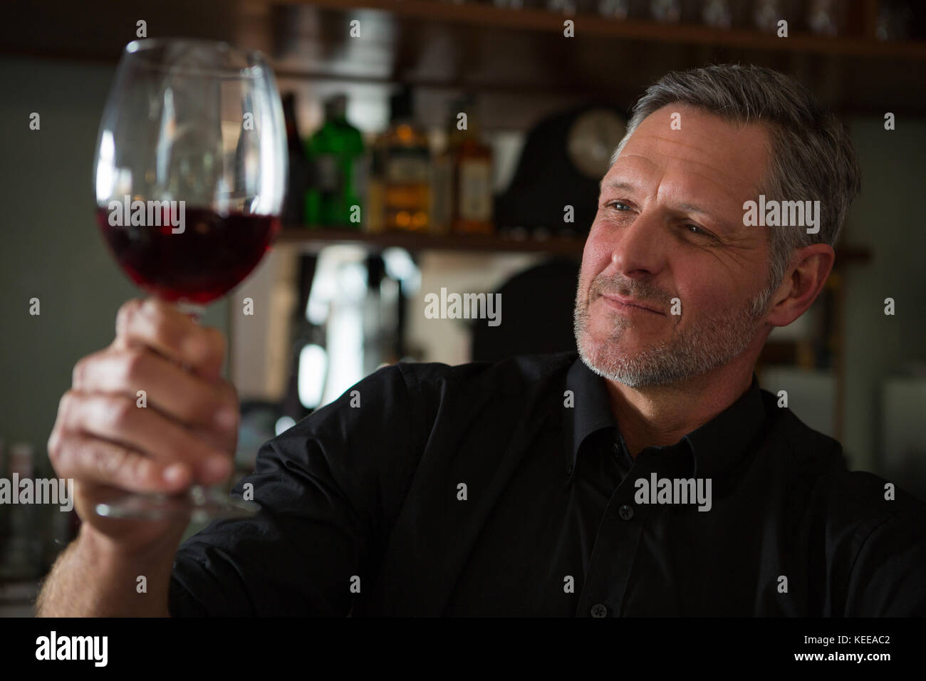Close-Up of waiter looking at a glass of wine in restaurant Stock Photo ...