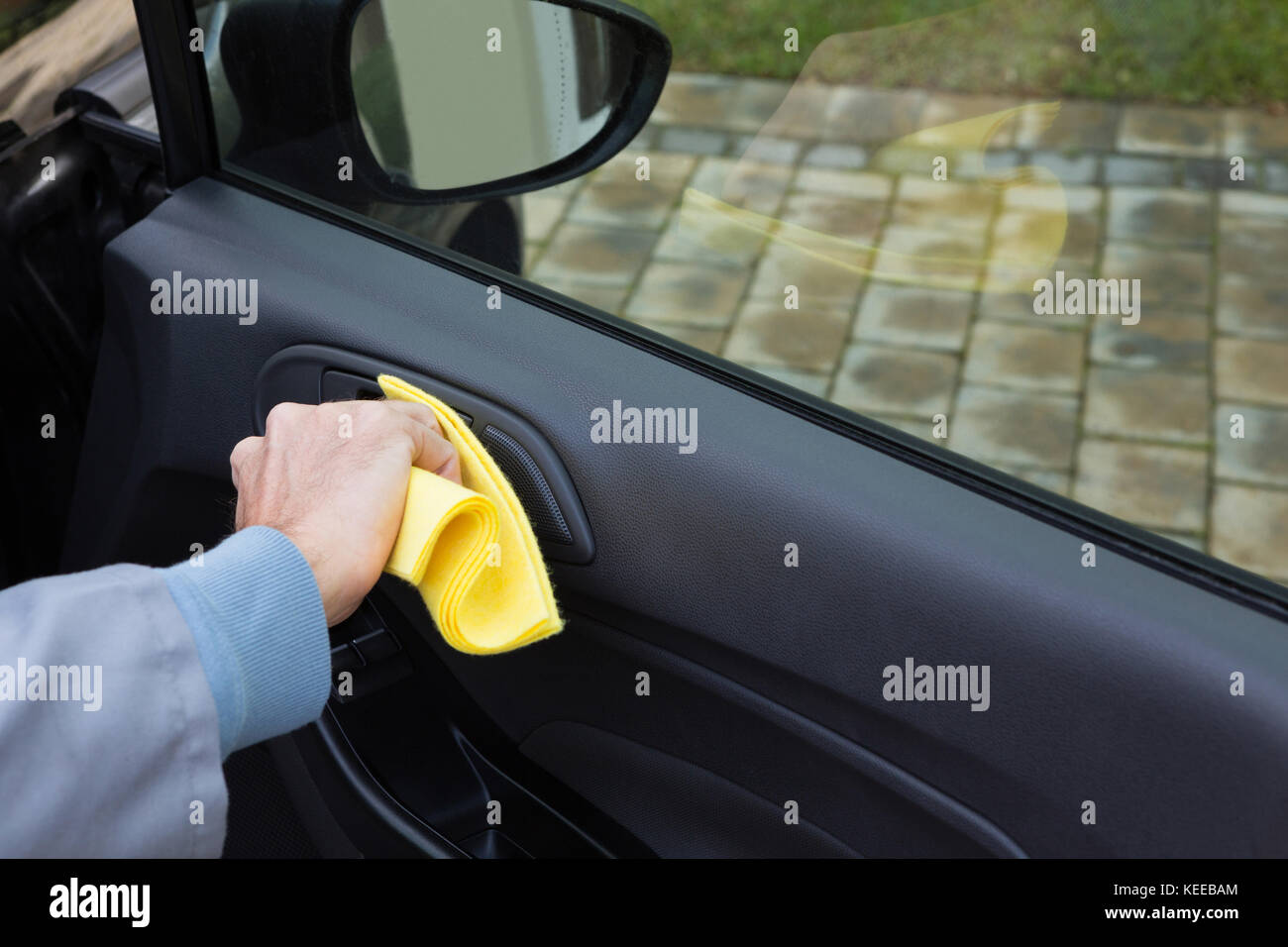 Male auto service staff cleaning car door Stock Photo Alamy
