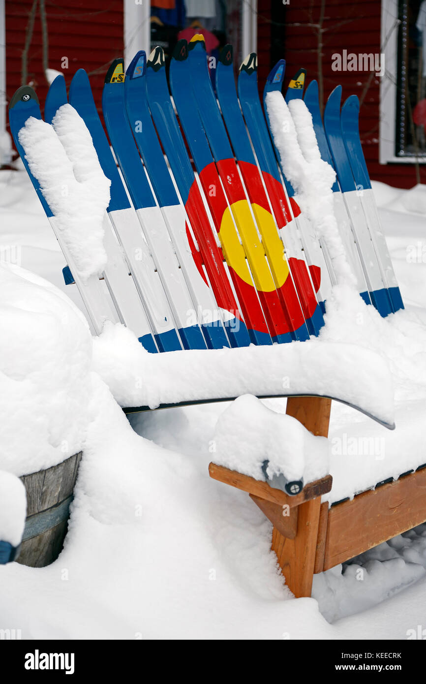 Bench made with skis and decorated with flag of State of Colorado, covered in snow, Breckenridge, Colorado USA Stock Photo